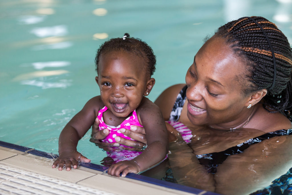 African mother and daughter in a swimming pool