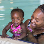 African mother and daughter in a swimming pool